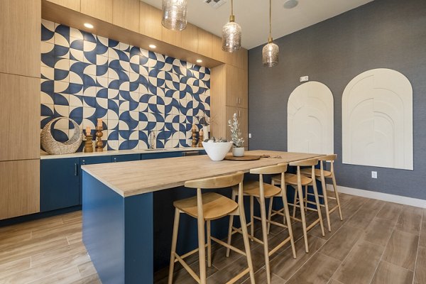 Stylish clubhouse with modern decor at Alta Berry Creek Apartments, featuring cozy seating areas and vibrant artwork