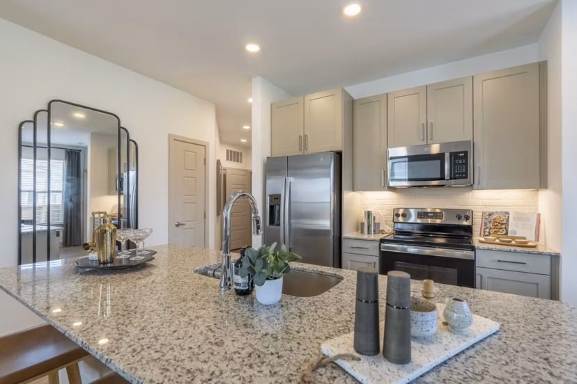 Modern kitchen featuring stainless steel appliances at Alta Berry Creek Apartments