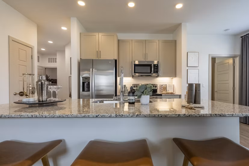 Modern kitchen with stainless steel appliances at Alta Berry Creek Apartments