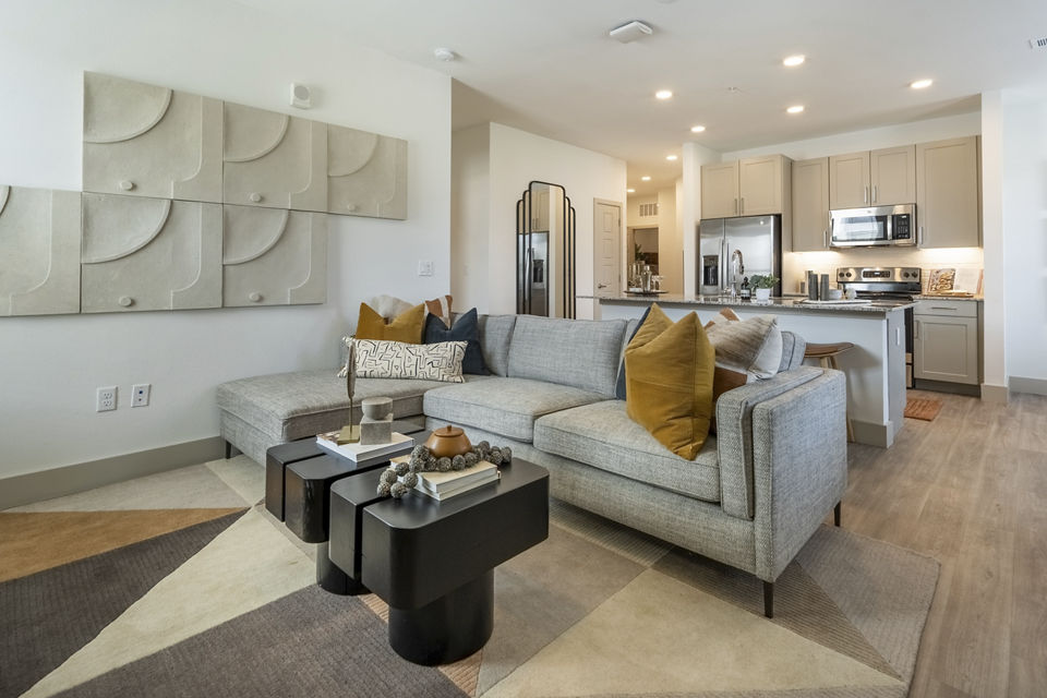 Spacious living room with modern decor and natural lighting in Alta Berry Creek Apartments