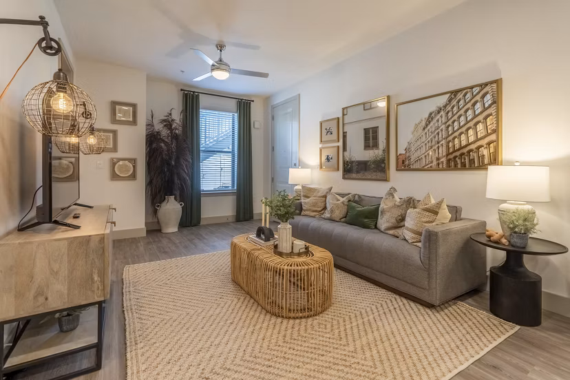 Spacious living room featuring modern decor and expansive windows at Alta Berry Creek Apartments