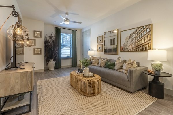 Spacious living room featuring modern decor and expansive windows at Alta Berry Creek Apartments