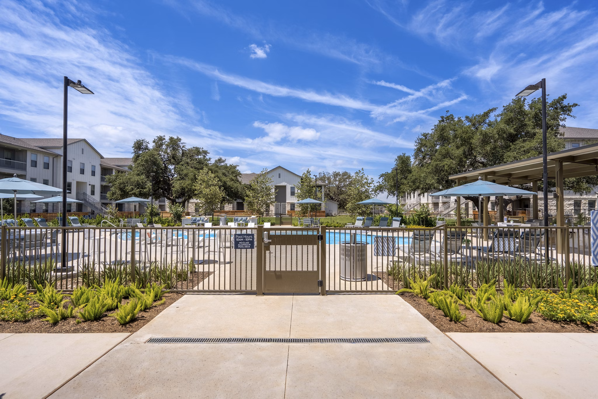 Modern pool with lounge area at Alta Berry Creek Apartments