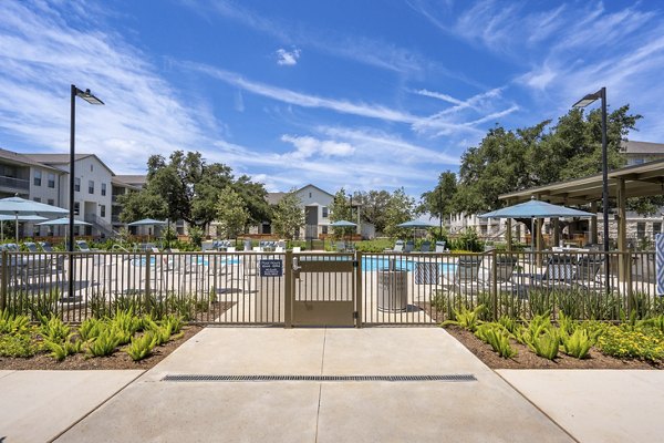 Modern pool with lounge area at Alta Berry Creek Apartments