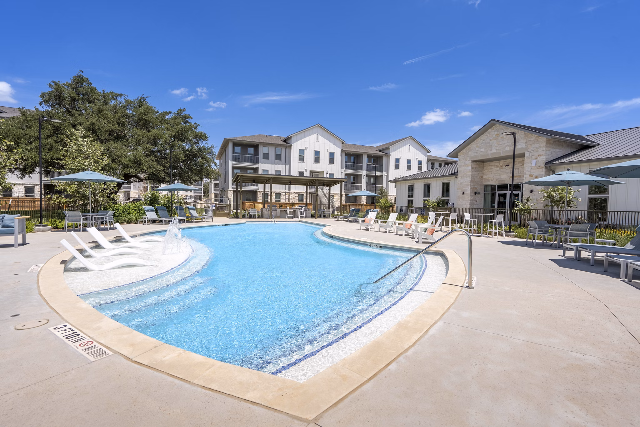 Luxurious outdoor pool at Alta Berry Creek Apartments with elegant poolside seating area