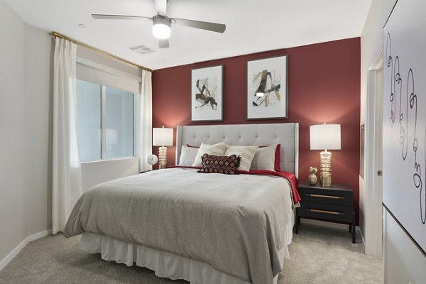 Cozy bedroom with elegant furnishings at Alta Biltmore Apartments in Phoenix, featuring luxury living by Greystar