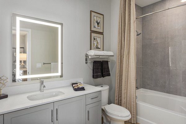 Alta Biltmore Apartments: Modern bathroom featuring sleek fixtures and natural lighting in luxury apartment community