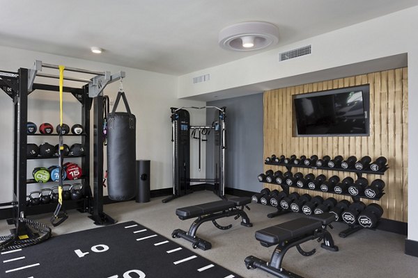 Modern fitness center equipped with state-of-the-art machines at Alta Biltmore Apartments, offering luxury living in a prime location