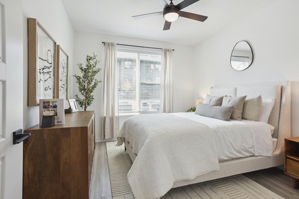 Spacious bedroom with modern decor at Alta City Side Apartments