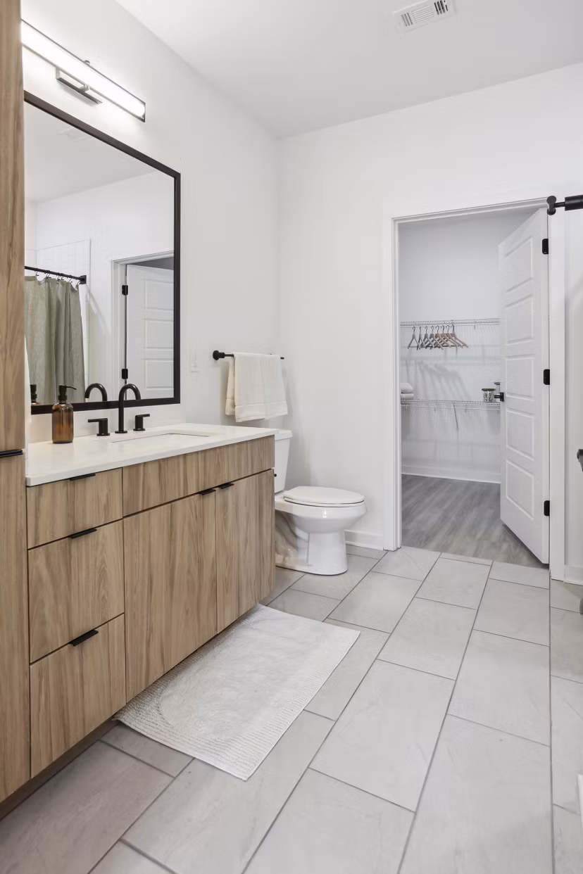 Bathroom with modern fixtures featuring a sleek vanity and glass shower at Alta City Side Apartments, luxury living in an urban setting