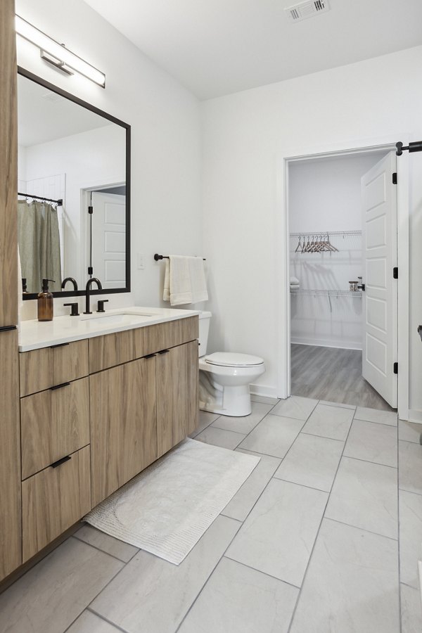 Bathroom with modern fixtures featuring a sleek vanity and glass shower at Alta City Side Apartments, luxury living in an urban setting