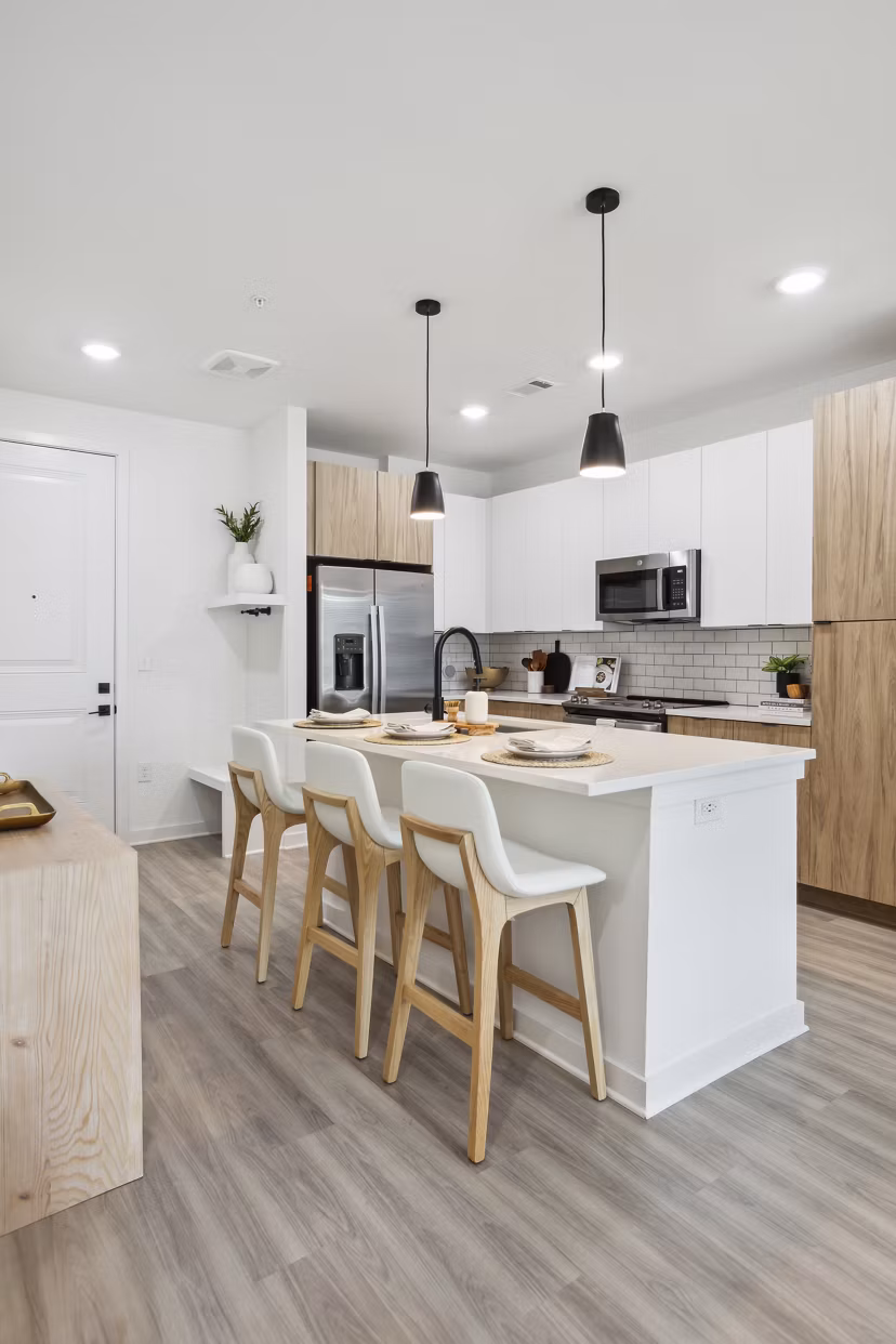 Modern kitchen featuring stainless steel appliances and granite countertops at Alta City Side Apartments