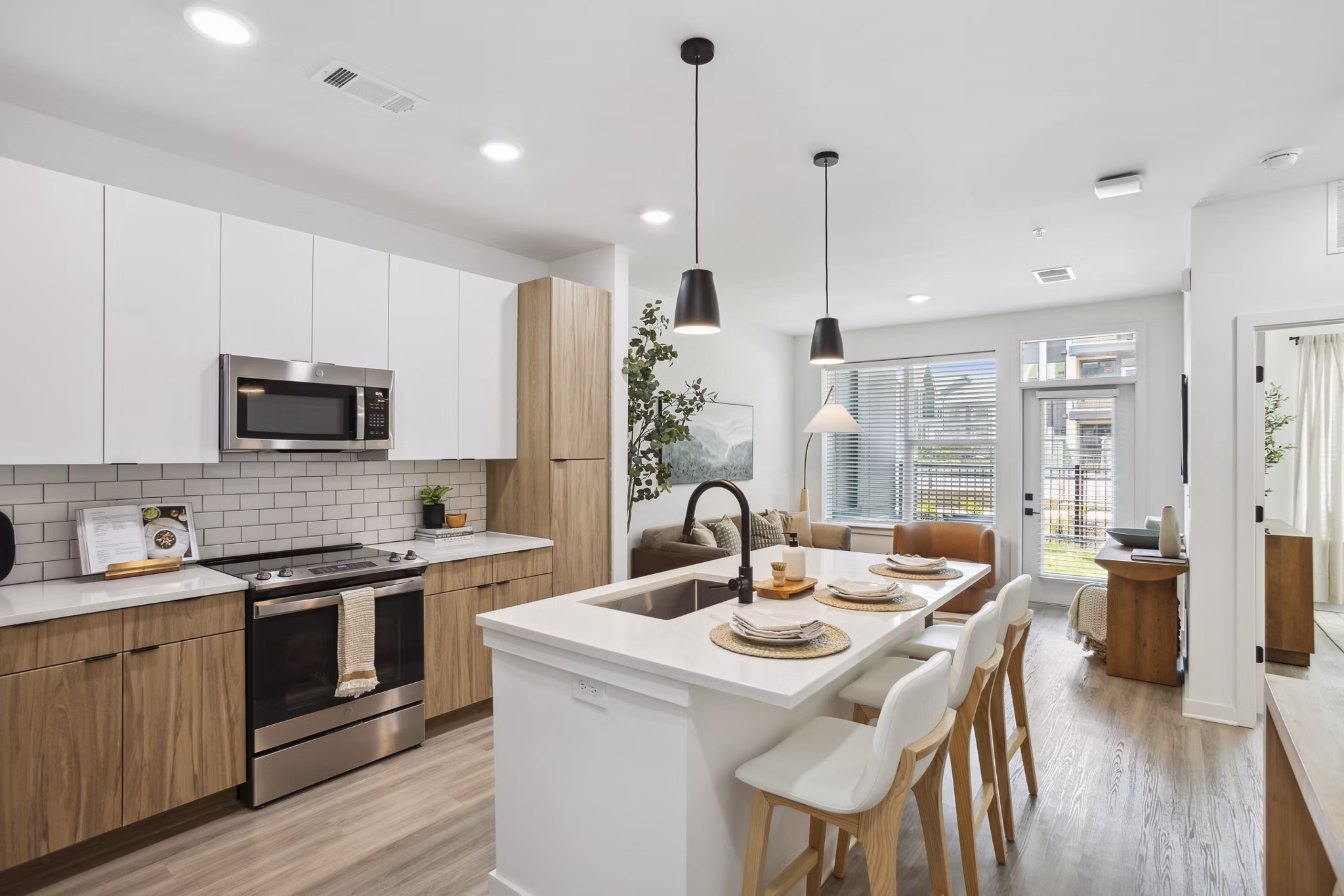 Modern kitchen with stainless steel appliances in Alta City Side Apartments