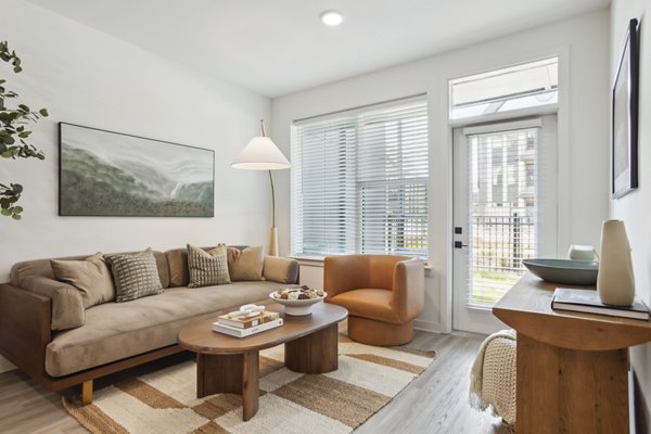 Spacious living room with modern decor at Alta City Side Apartments featuring luxury design elements