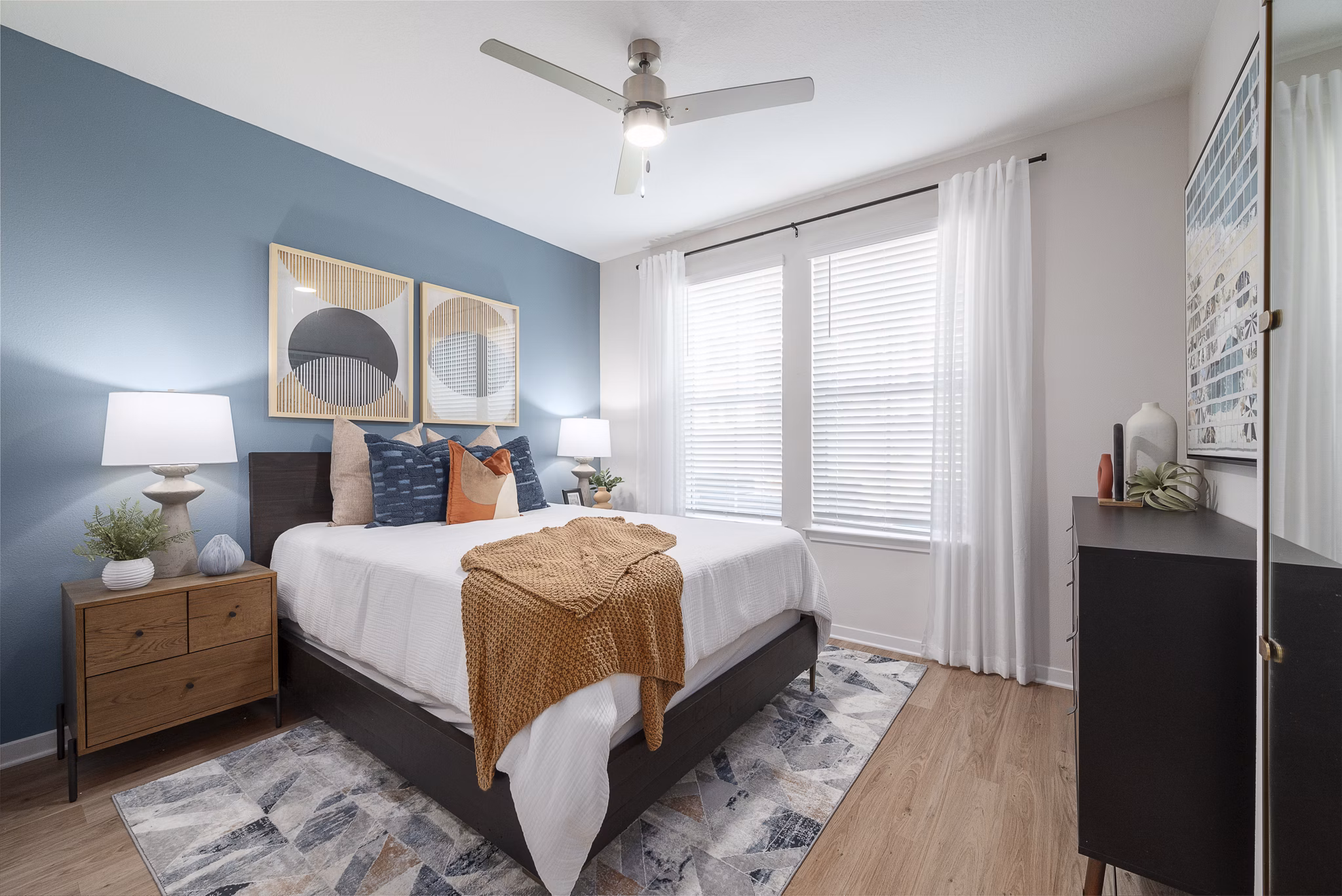 Cozy bedroom featuring a plush bed and modern decor at Alta Citron Apartments, luxury living by Greystar