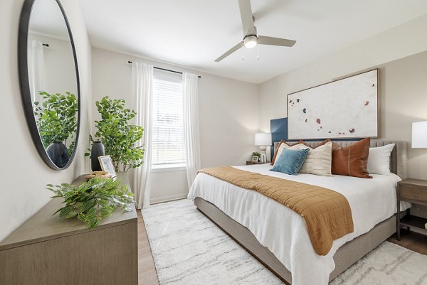 Comfortable bedroom with elegant decor at Alta Citron Apartments, a Greystar luxury property