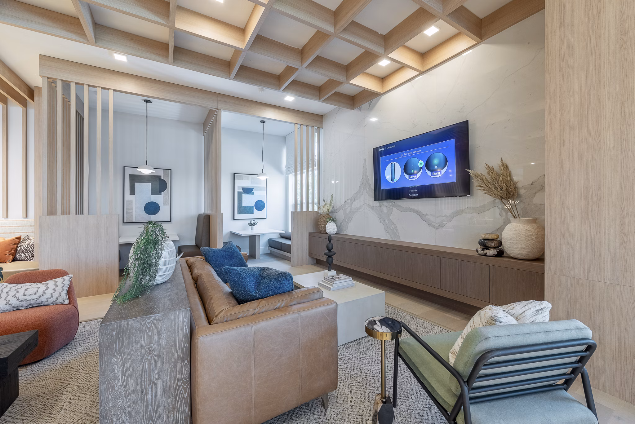 Clubroom with modern furnishings and expansive windows at Alta Citron Apartments, luxury living destination