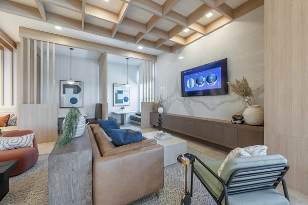 Clubroom with modern furnishings and expansive windows at Alta Citron Apartments, luxury living destination