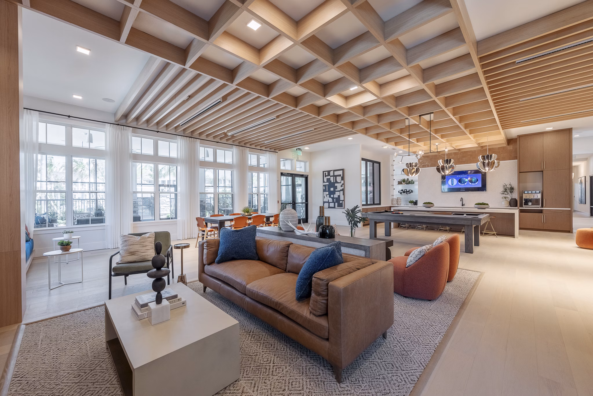 Clubroom with modern seating and game tables at Alta Citron Apartments