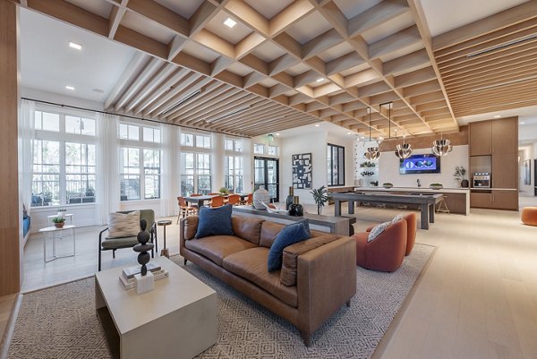 Clubroom with modern seating and game tables at Alta Citron Apartments