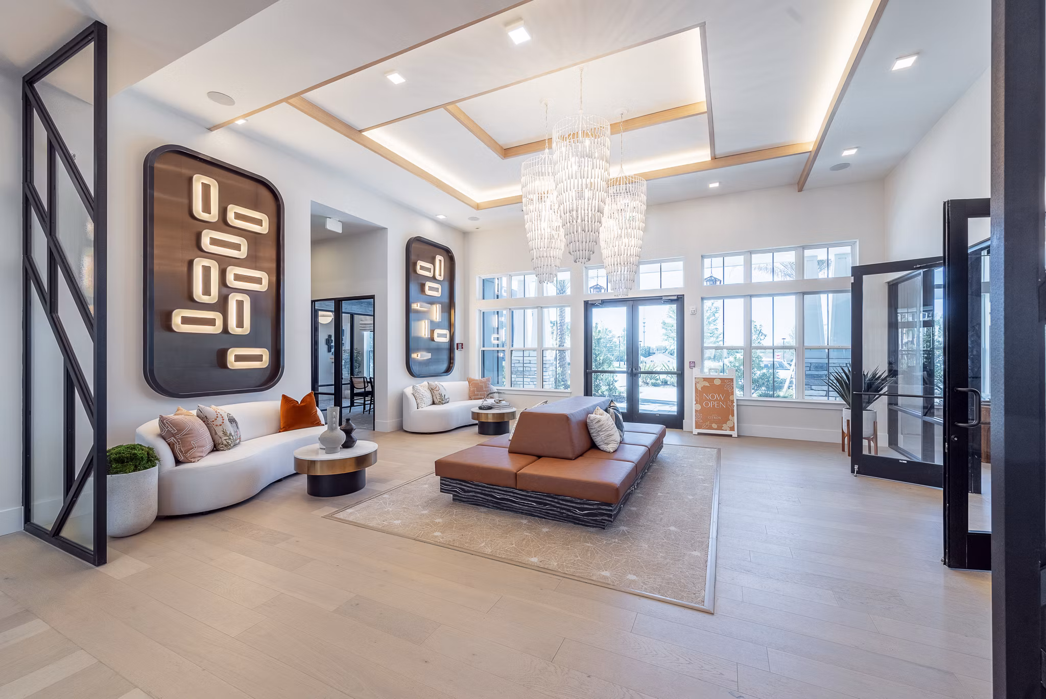 Clubroom with modern furnishings and large windows at Alta Citron Apartments, luxury living space in a vibrant community