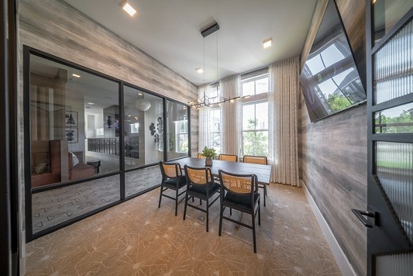 Modern clubroom with cozy seating and large windows at Alta Citron Apartments, offering a luxurious community experience