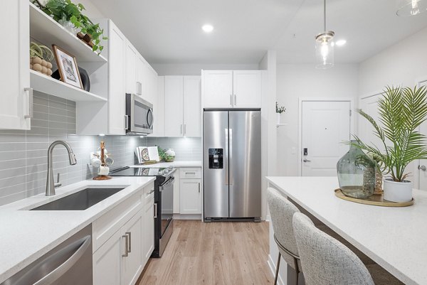 Modern kitchen with stainless steel appliances at Alta Citron Apartments, Greystar luxury living