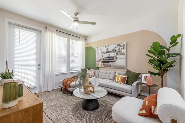 Spacious living room with modern decor and natural light at Alta Citron Apartments