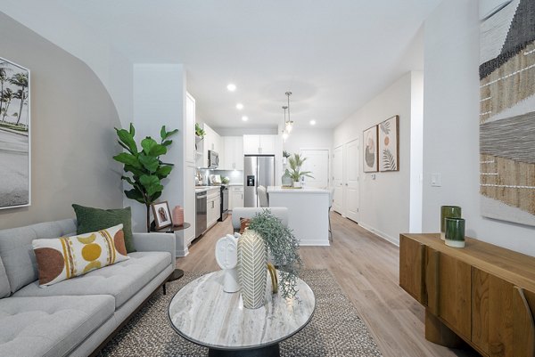 Spacious living room with modern decor and large windows at Alta Citron Apartments, luxury living with Greystar's exceptional design