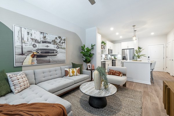Spacious living room with modern decor and ample natural light in Alta Citron Apartments, luxury living at its best
