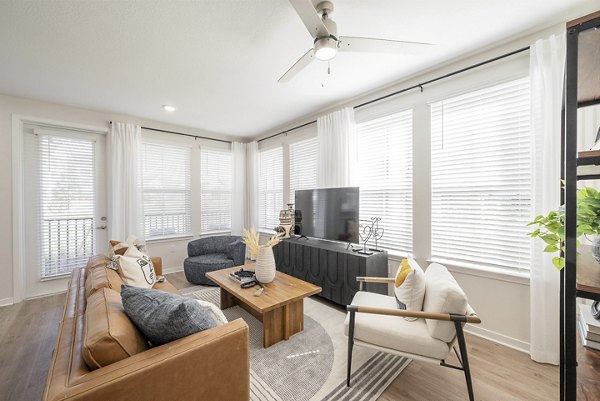 Spacious living room with modern design and natural light in Alta Citron Apartments, perfect for luxury living