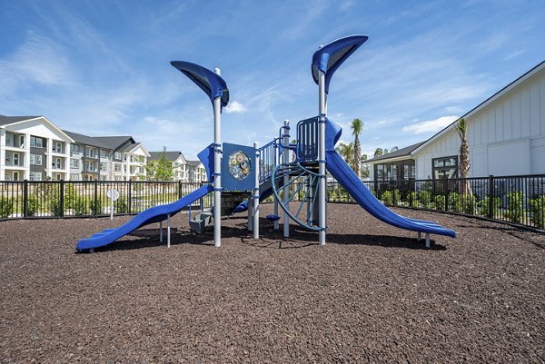 Recreational area featuring modern outdoor seating and lush greenery at Alta Citron apartments