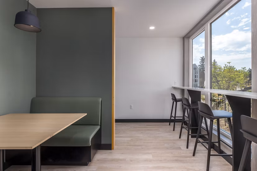 Clubhouse at Alta Civic Station: Modern clubhouse featuring a cozy lounge area and community gaming tables in a luxury apartment complex