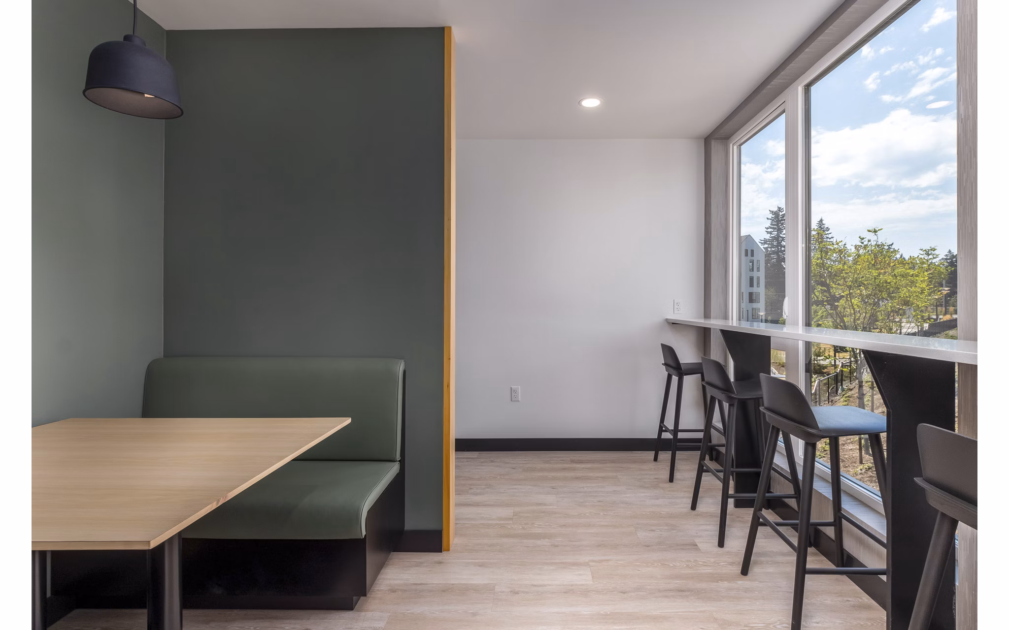Clubhouse at Alta Civic Station: Modern clubhouse featuring a cozy lounge area and community gaming tables in a luxury apartment complex