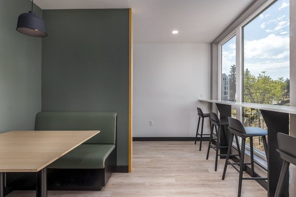 Clubhouse at Alta Civic Station: Modern clubhouse featuring a cozy lounge area and community gaming tables in a luxury apartment complex