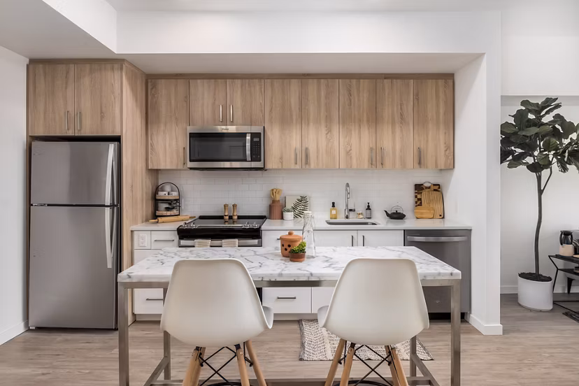 Modern kitchen with quartz countertops and stainless steel appliances at Alta Civic Station luxury apartments