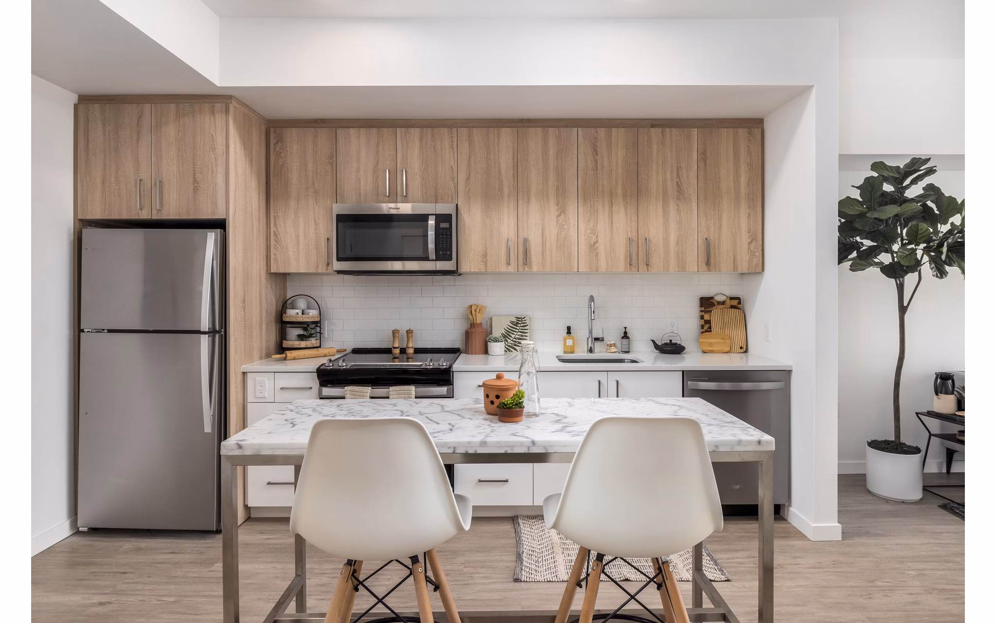 Modern kitchen with quartz countertops and stainless steel appliances at Alta Civic Station luxury apartments