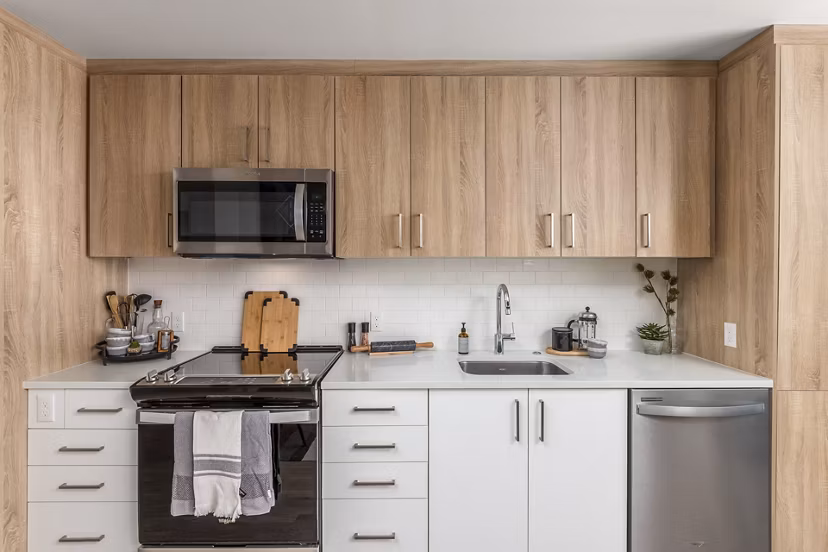 Kitchen featuring modern appliances and granite countertops in Alta Civic Station apartments