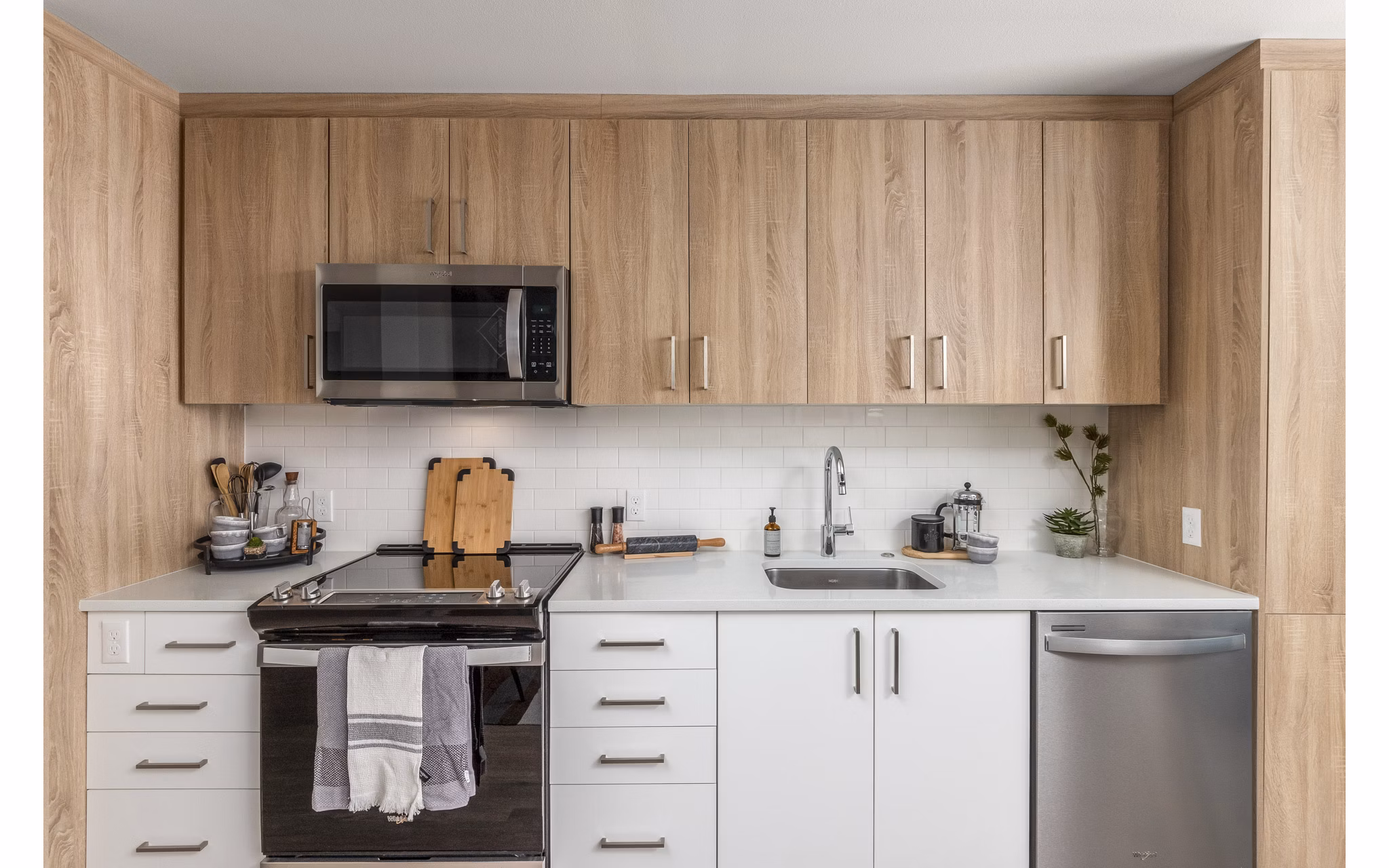Kitchen featuring modern appliances and granite countertops in Alta Civic Station apartments