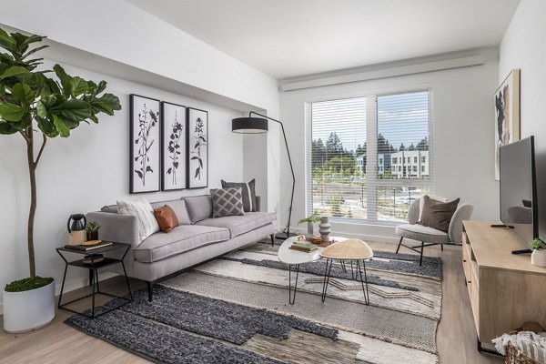 Living room featuring modern furnishings and natural light at Alta Civic Station