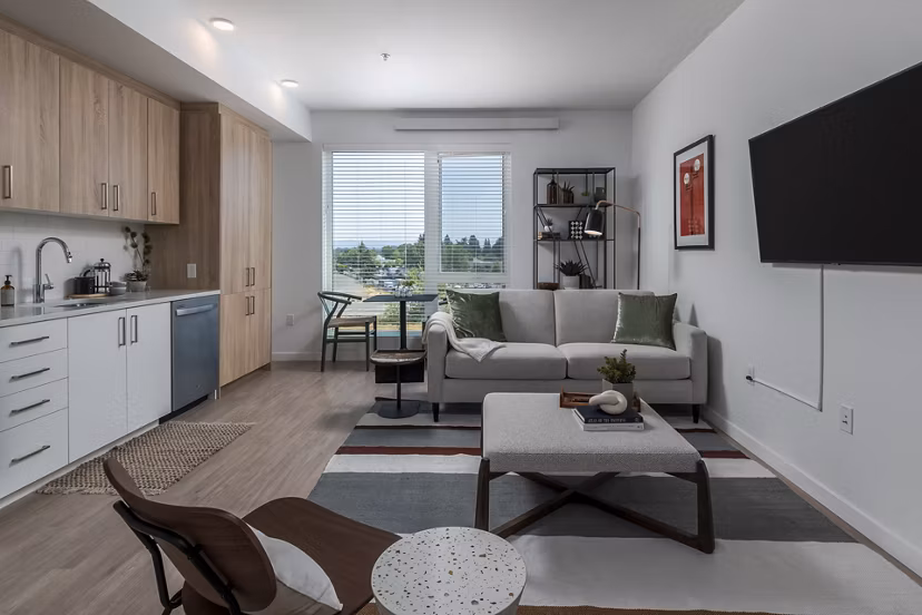 Contemporary living room featuring sleek furniture and large windows at Alta Civic Station luxury apartments