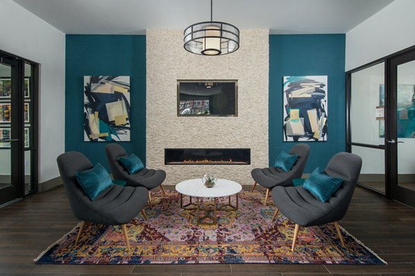 Contemporary clubhouse featuring a cozy lounge at Alta Clara at the Fells apartments