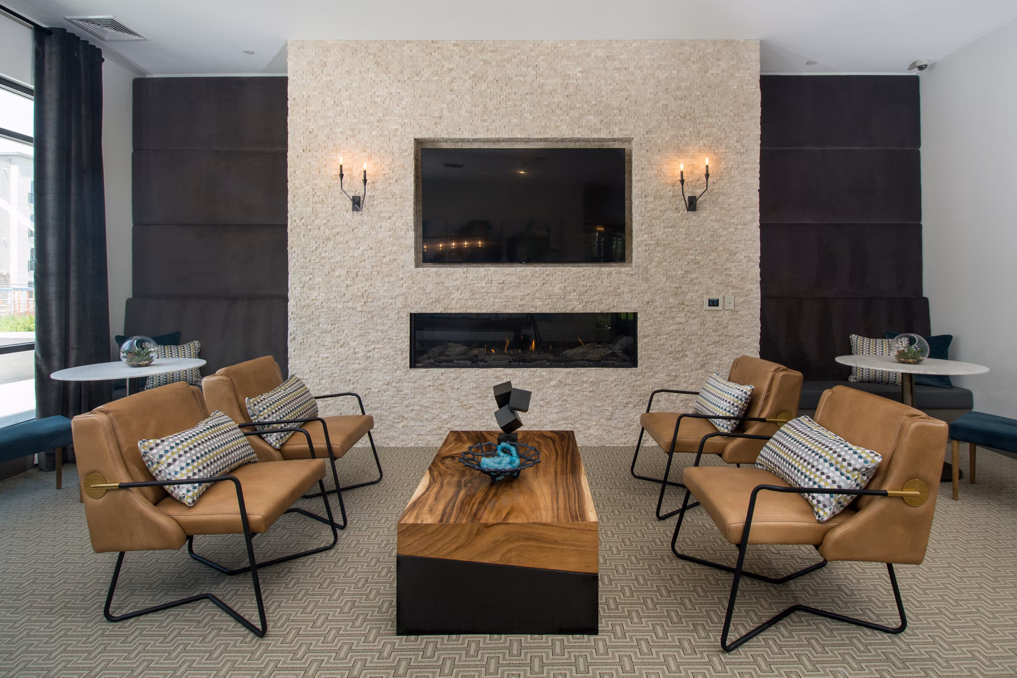 Clubhouse featuring modern design and seating areas at Alta Clara at the Fells Apartments