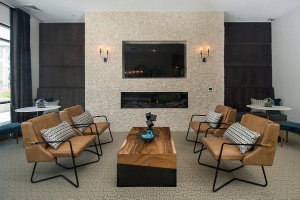 Clubhouse featuring modern design and seating areas at Alta Clara at the Fells Apartments