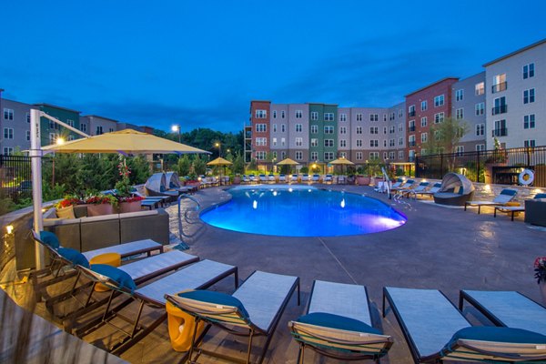 Inviting outdoor pool area at Alta Clara at the Fells Apartments, offering luxury relaxation and leisure spaces for residents