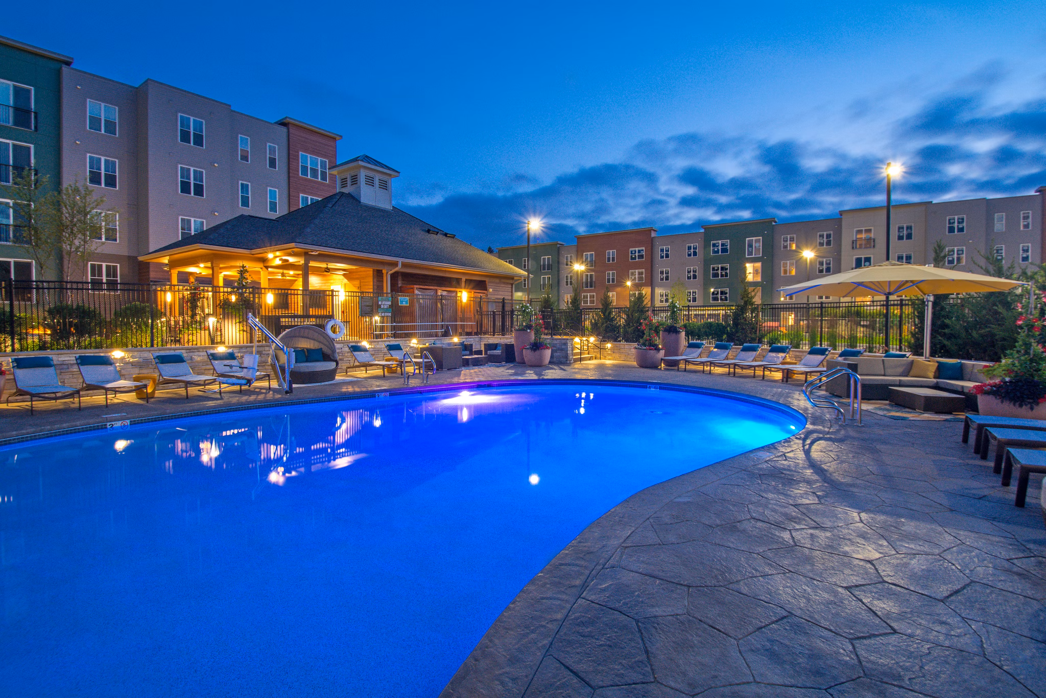 Luxurious pool with sun deck at Alta Clara at the Fells Apartments