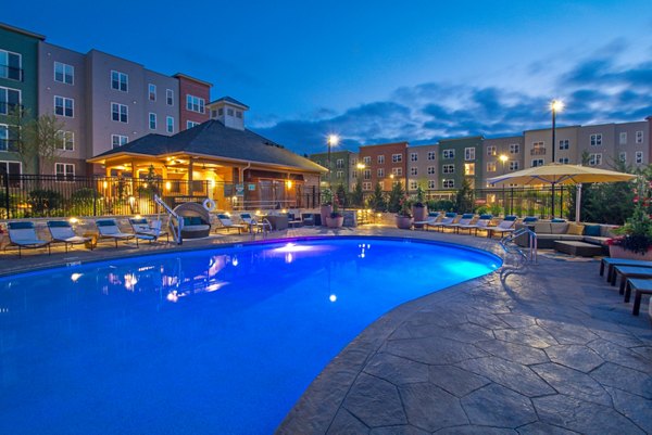 Luxurious pool with sun deck at Alta Clara at the Fells Apartments