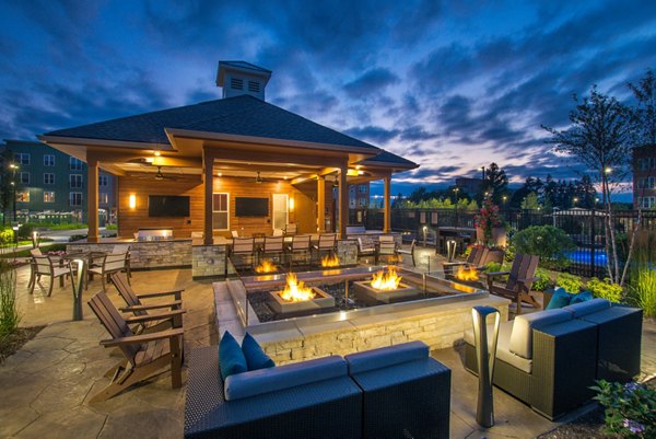 Fire pit seating area with cozy ambience at Alta Clara at the Fells Apartments