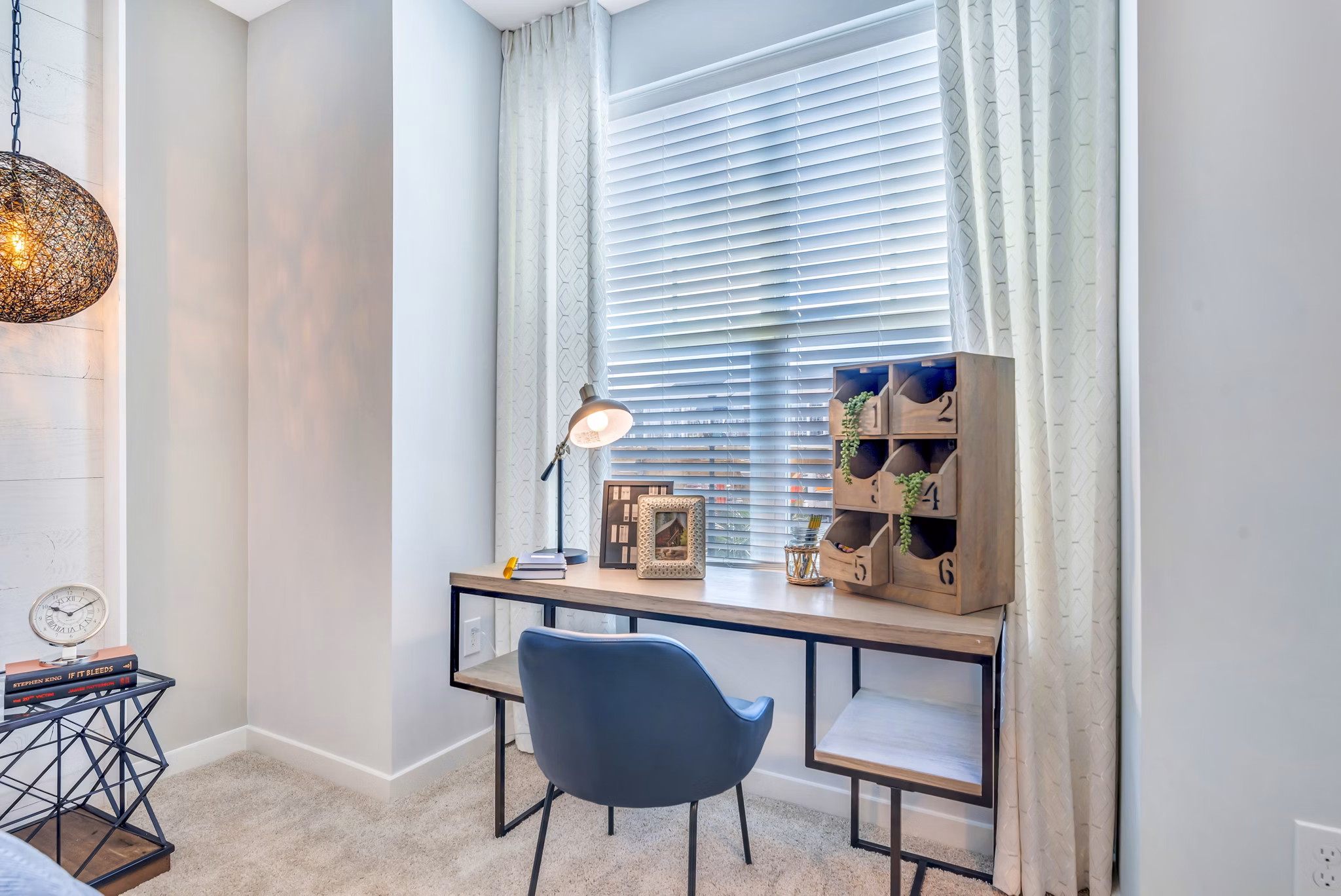 Bedroom with home office setup at Alta Croft Apartments featuring a modern desk and cozy bed