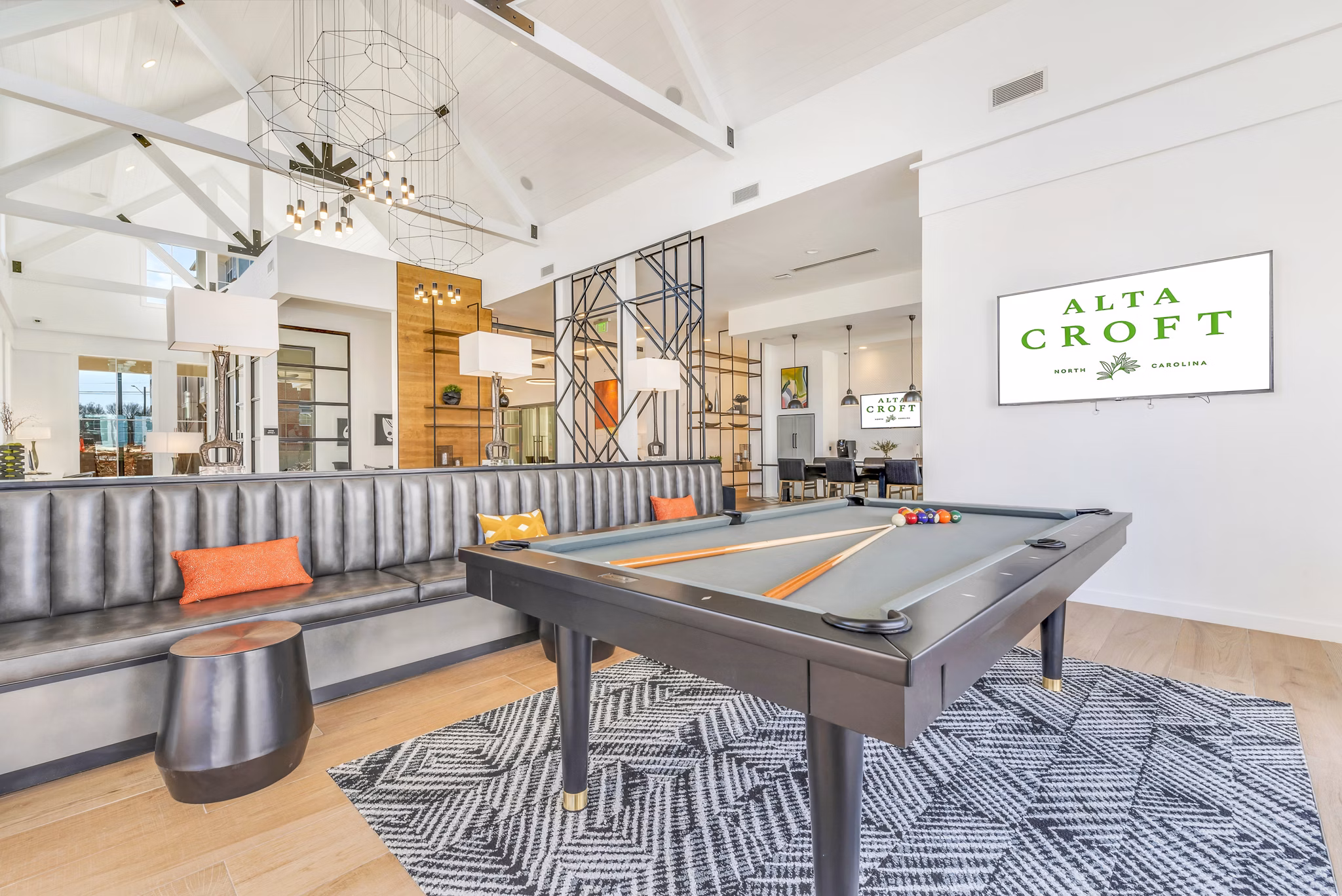 Game room with pool table and modern seating at Alta Croft Apartments for leisure and entertainment